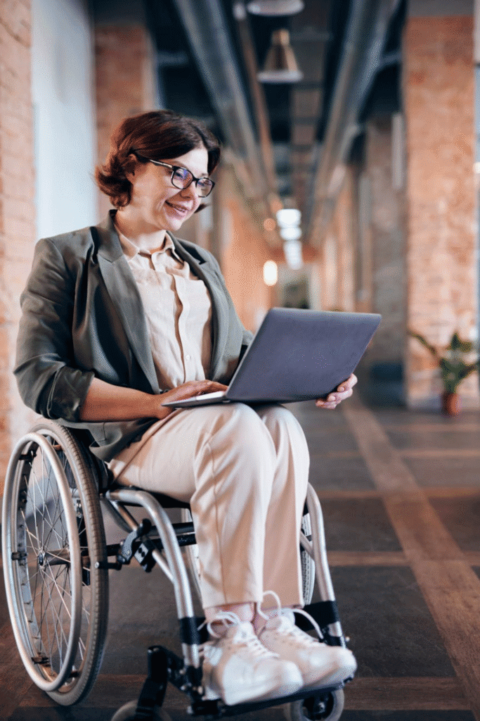 woman in a wheelchair working on a laptop
