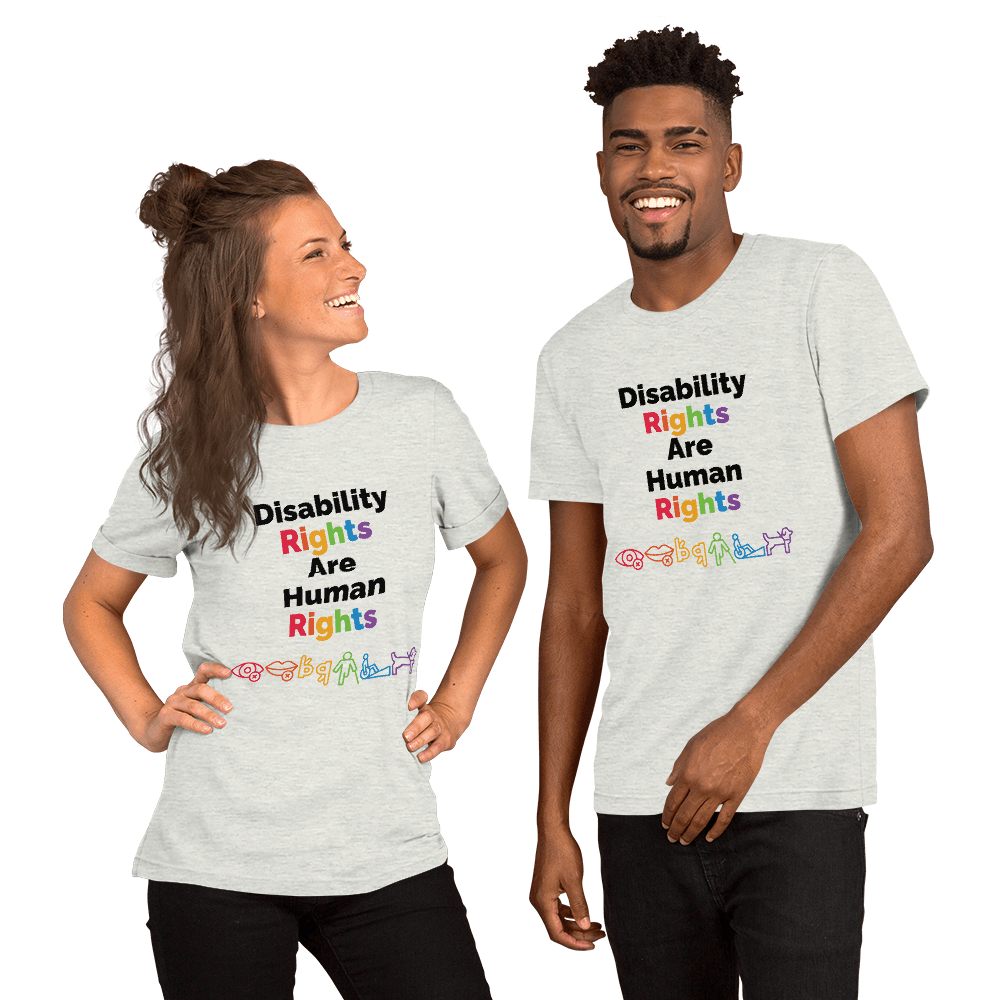 A white woman with long brown hair and a black man with short hair smile posing wearing a shirt from the A11yShop that reads Disability Rights are Human Rights with a rainbow of icons representing different disabilities.